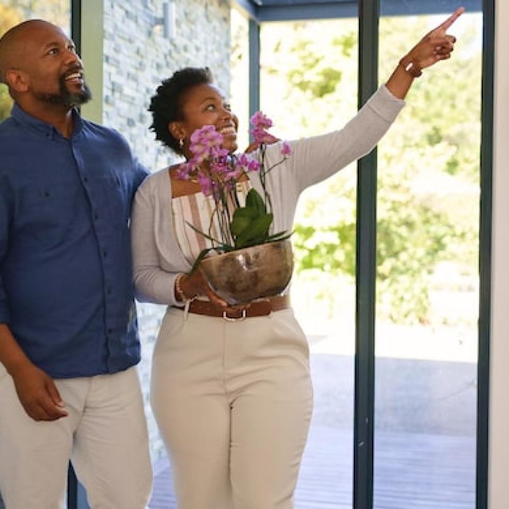 couple-flowers-happy-new-home-real-estate-with-property-investment-fresh-start-support-black-people-man-woman-with-pot-plant-pointing-moving-excited-achievement_590464-275479